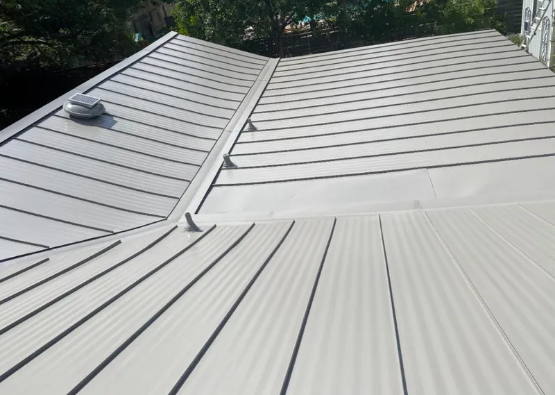 Solar attic fan installed on a metal roof for Roof Ventilation in Smithtown